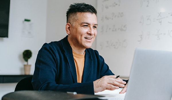 Man smiling at computer